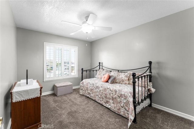 bedroom with carpet floors, a textured ceiling, baseboards, and a ceiling fan