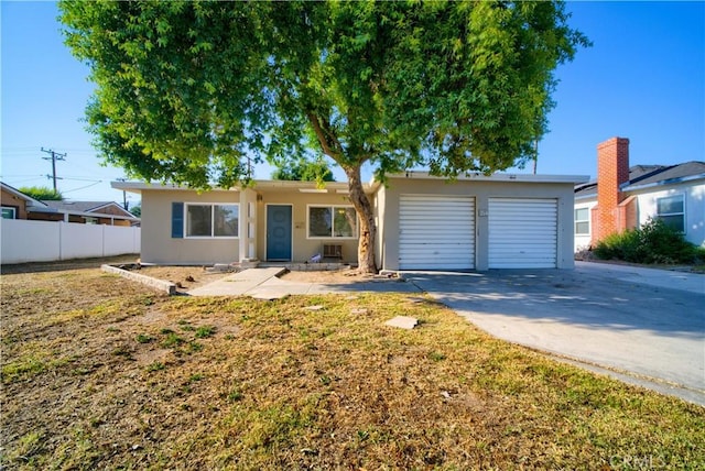 214 E Marshall Blvd, San Bernardino, CA 92404 - ranch-style house featuring concrete driveway, a garage, and stucco siding