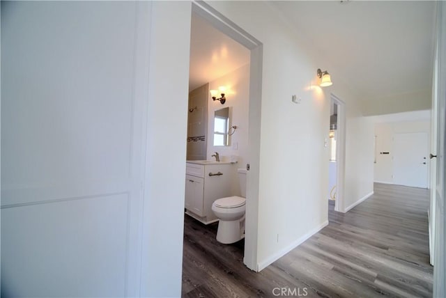 214 E Marshall Blvd, San Bernardino, CA 92404 - corridor featuring wood finished floors and baseboards