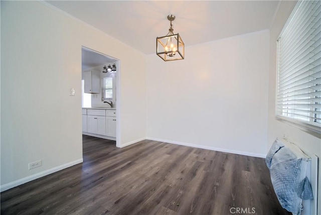 214 E Marshall Blvd, San Bernardino, CA 92404 - unfurnished dining area featuring a chandelier, dark wood-type flooring, and ornamental molding