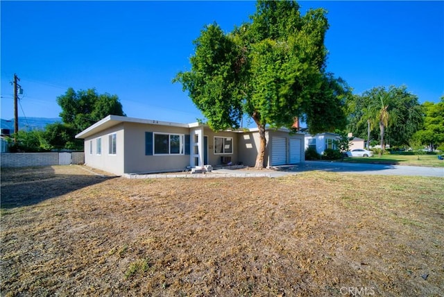 214 E Marshall Blvd, San Bernardino, CA 92404 - ranch-style home with driveway, an attached garage, and stucco siding