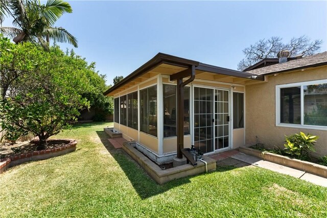 1467 W Southgate Ave, Fullerton, CA 92833 - view of property exterior with a sunroom, stucco siding, and a yard