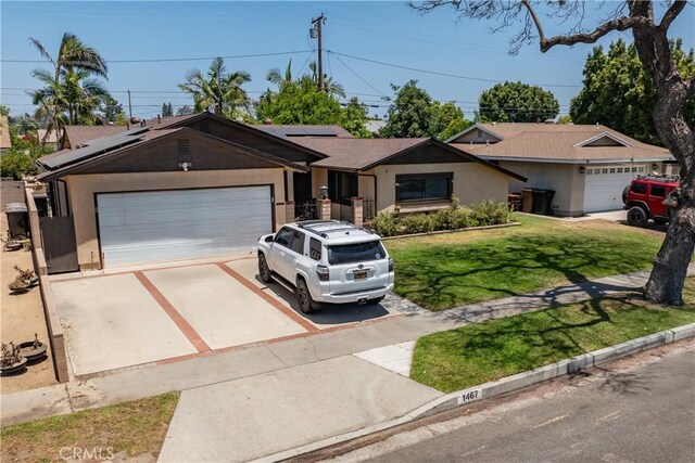 1467 W Southgate Ave, Fullerton, CA 92833 - ranch-style house featuring a front yard, driveway, roof mounted solar panels, an attached garage, and stucco siding