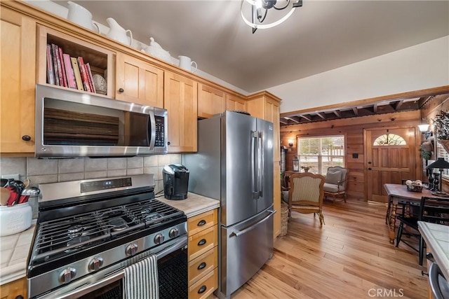795 Glen View Ln, Twin Peaks, CA 92391 - kitchen with stainless steel appliances, light wood finished floors, decorative backsplash, wooden walls, and light brown cabinets