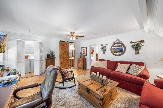 795 Glen View Ln, Twin Peaks, CA 92391 - living room featuring a barn door, washing machine and clothes dryer, ceiling fan, and beamed ceiling