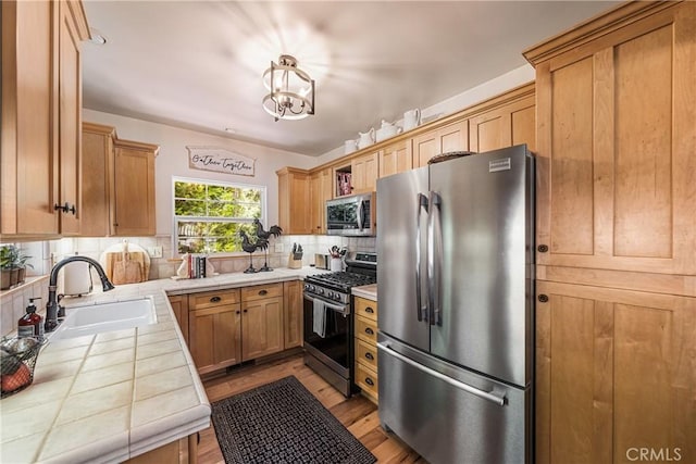 795 Glen View Ln, Twin Peaks, CA 92391 - kitchen featuring stainless steel appliances, tile countertops, a sink, decorative backsplash, and wood finished floors