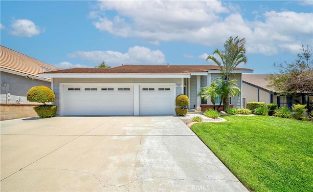 ranch-style house with concrete driveway, a front lawn, and an attached garage