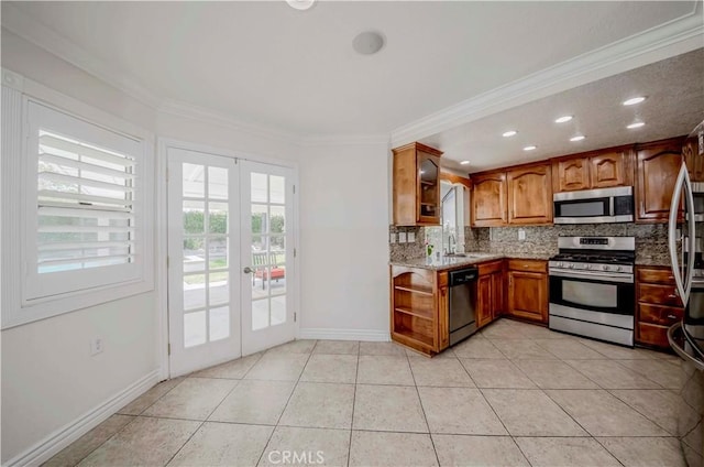 kitchen with stainless steel appliances, french doors, tasteful backsplash, brown cabinets, and ornamental molding