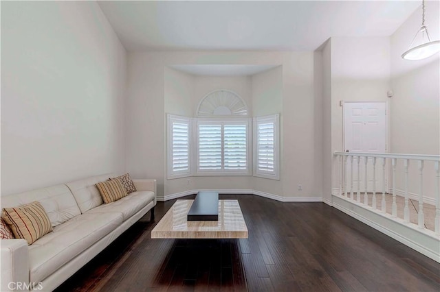 living room featuring dark wood-type flooring and baseboards