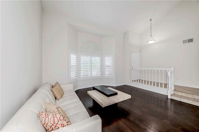 living room with wood finished floors and lofted ceiling
