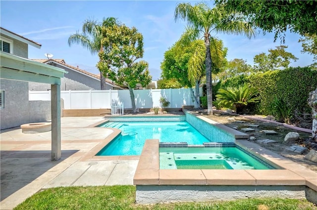 view of pool featuring a patio area, a pool with connected hot tub, and a fenced backyard