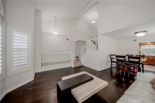 living area featuring wood finished floors, stairway, baseboards, and high vaulted ceiling