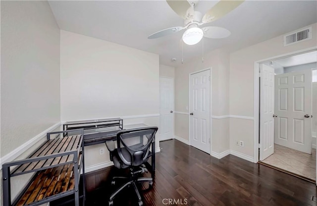 office featuring wood finished floors, a ceiling fan, and baseboards