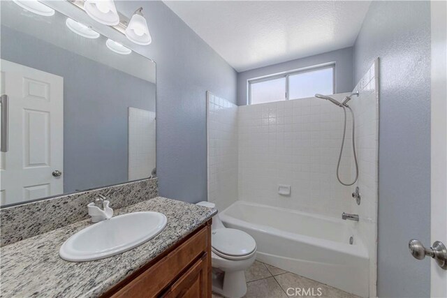 full bathroom with toilet, tile patterned flooring, vanity, and bathing tub / shower combination