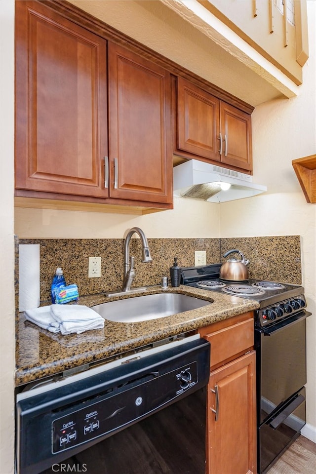 7540 Henness Cir Unit B206, Yosemite, CA 95389 - kitchen with under cabinet range hood, black appliances, stone counters, a sink, and brown cabinetry