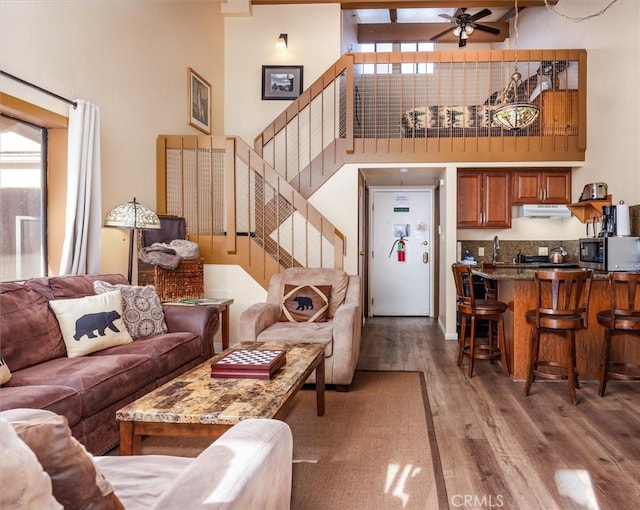7540 Henness Cir Unit B206, Yosemite, CA 95389 - living area featuring a high ceiling, wood finished floors, stairway, a ceiling fan, and healthy amount of natural light