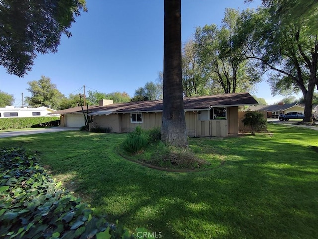 4752 Barrington Ct, Riverside, CA 92506 - view of property exterior featuring an attached garage, a lawn, a chimney, and driveway