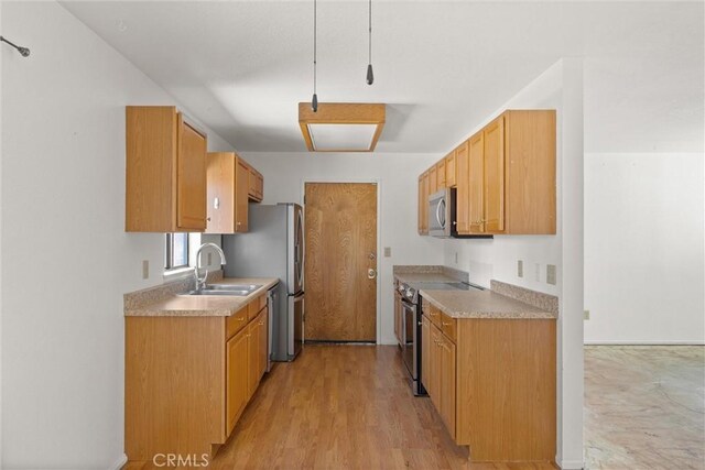 6383 Harvey Rd, Paradise, CA 95969 - kitchen with appliances with stainless steel finishes, a sink, light countertops, and light wood-type flooring
