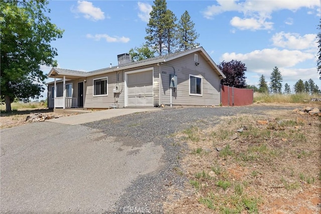 6383 Harvey Rd, Paradise, CA 95969 - ranch-style house with a garage, gravel driveway, and a chimney