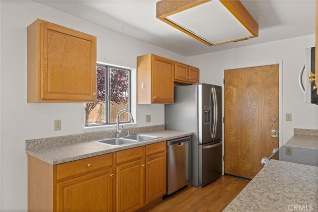 6383 Harvey Rd, Paradise, CA 95969 - kitchen featuring appliances with stainless steel finishes, a sink, light wood-type flooring, and light countertops