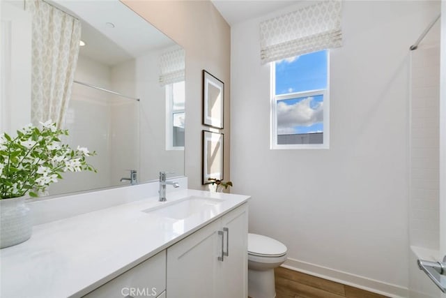 73 Culture, Irvine, CA 92618 - bathroom featuring vanity, toilet, wood finished floors, baseboards, and plenty of natural light