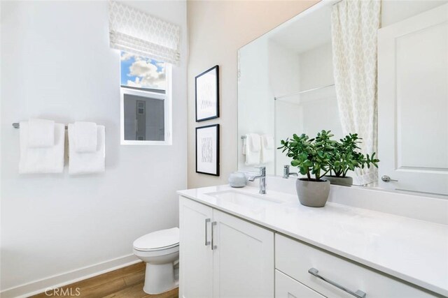 73 Culture, Irvine, CA 92618 - bathroom featuring toilet, vanity, wood finished floors, and baseboards