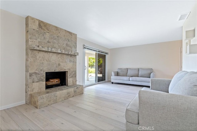 622 S Halcyon Rd, Arroyo Grande, CA 93420 - living area featuring wood finished floors, a tiled fireplace, and baseboards