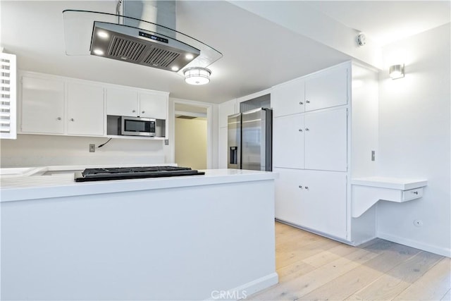622 S Halcyon Rd, Arroyo Grande, CA 93420 - kitchen with appliances with stainless steel finishes, light wood-type flooring, white cabinetry, light countertops, and a peninsula