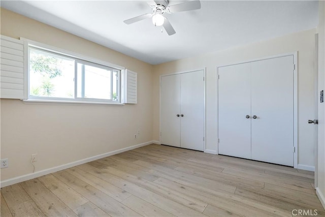 622 S Halcyon Rd, Arroyo Grande, CA 93420 - unfurnished bedroom with multiple closets, light wood-style flooring, and baseboards