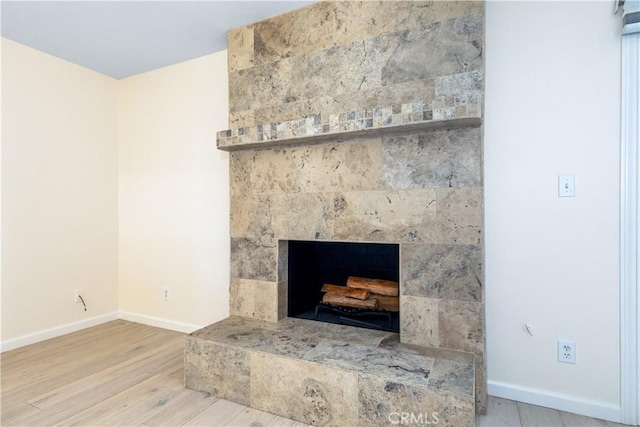 622 S Halcyon Rd, Arroyo Grande, CA 93420 - detailed view of wood finished floors, baseboards, and a fireplace