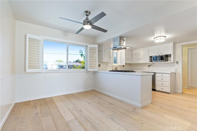 622 S Halcyon Rd, Arroyo Grande, CA 93420 - kitchen with appliances with stainless steel finishes, light wood-style flooring, white cabinetry, a peninsula, and ventilation hood