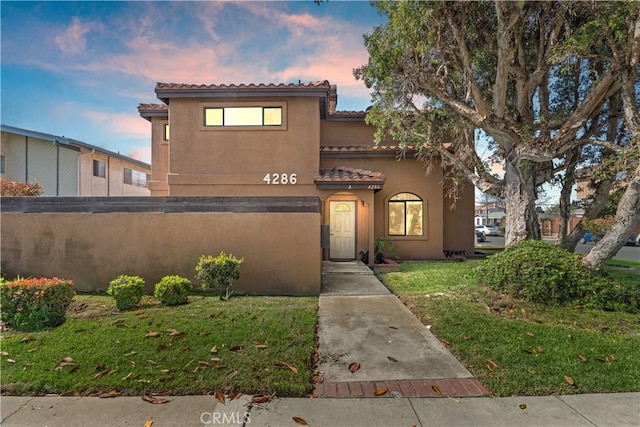 4286 W 182nd St Unit A, Torrance, CA 90504 - mediterranean / spanish-style home featuring stucco siding, a tiled roof, and a front lawn