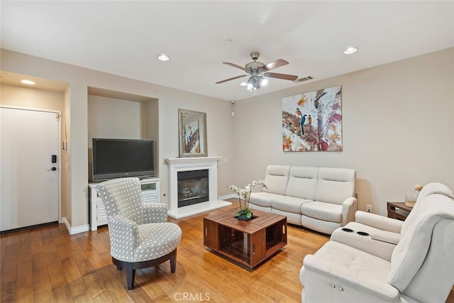 15561 Jasmine Pl, Tustin, CA 92782 - living room with recessed lighting, light wood-type flooring, ceiling fan, baseboards, and a glass covered fireplace