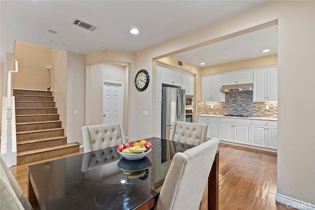 15561 Jasmine Pl, Tustin, CA 92782 - dining area with light wood-style flooring, stairway, and recessed lighting