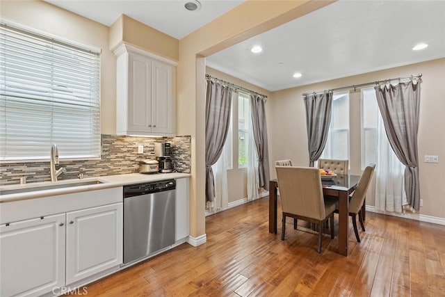 15561 Jasmine Pl, Tustin, CA 92782 - kitchen featuring dishwasher, a sink, tasteful backsplash, light countertops, and light wood-style flooring