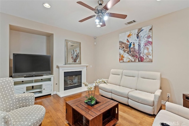 15561 Jasmine Pl, Tustin, CA 92782 - living room featuring ceiling fan, a glass covered fireplace, wood finished floors, and recessed lighting
