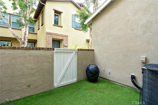 15561 Jasmine Pl, Tustin, CA 92782 - view of yard featuring central air condition unit and a gate