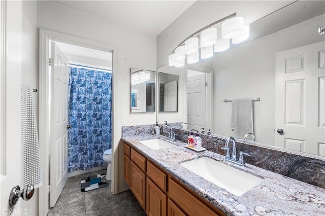 3410 Genoa Pl, Palmdale, CA 93551 - full bath featuring toilet, double vanity, curtained shower, and tile patterned flooring