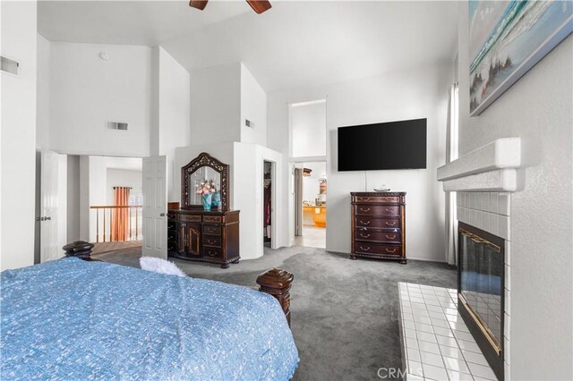 3410 Genoa Pl, Palmdale, CA 93551 - bedroom featuring high vaulted ceiling, carpet floors, a tiled fireplace, connected bathroom, and a ceiling fan