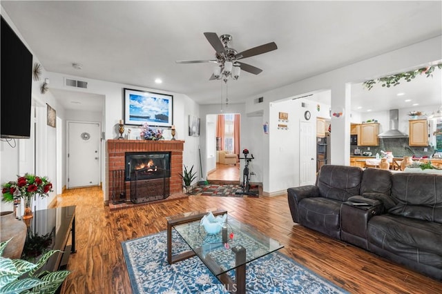 3410 Genoa Pl, Palmdale, CA 93551 - living room featuring a ceiling fan, wood finished floors, a brick fireplace, and recessed lighting