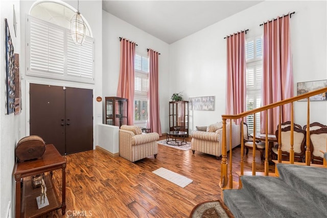3410 Genoa Pl, Palmdale, CA 93551 - living room with stairs, wood finished floors, and high vaulted ceiling
