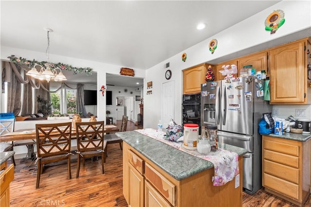 3410 Genoa Pl, Palmdale, CA 93551 - kitchen featuring stainless steel fridge, wood finished floors, a chandelier, a kitchen island, and oven