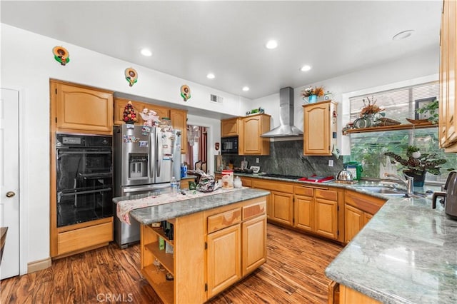3410 Genoa Pl, Palmdale, CA 93551 - kitchen featuring wall chimney exhaust hood, black appliances, a sink, tasteful backsplash, and wood finished floors