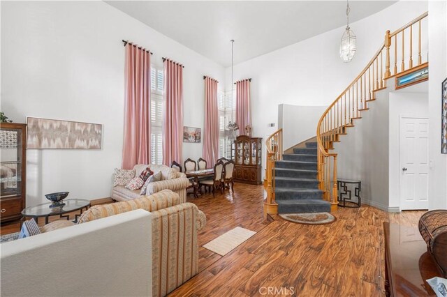 3410 Genoa Pl, Palmdale, CA 93551 - living area with stairway, wood finished floors, and baseboards