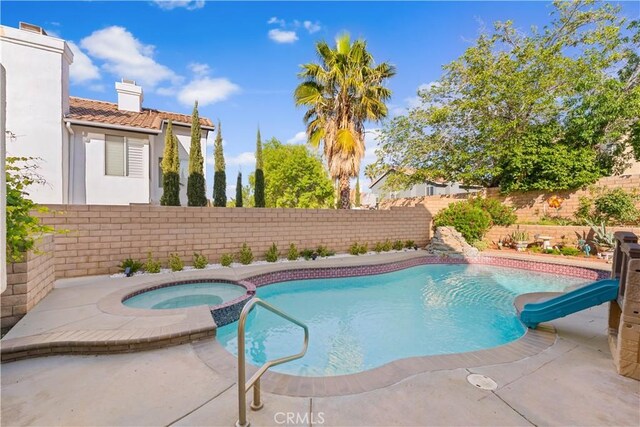 3410 Genoa Pl, Palmdale, CA 93551 - view of swimming pool with a water slide, a fenced backyard, and an in-ground hot tub