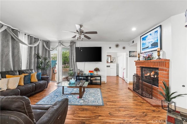 3410 Genoa Pl, Palmdale, CA 93551 - living area featuring ceiling fan, wood finished floors, a brick fireplace, and recessed lighting