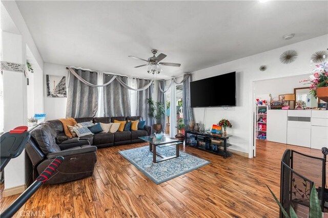 3410 Genoa Pl, Palmdale, CA 93551 - living area featuring a ceiling fan, wood finished floors, and baseboards