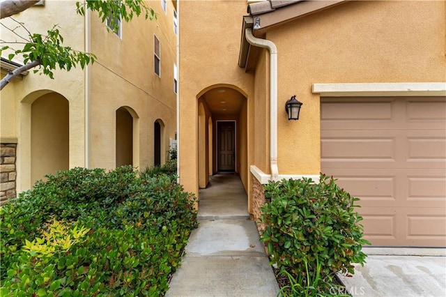 20304 Estuary Ln, Newport Beach, CA 92660 - property entrance featuring stucco siding and an attached garage