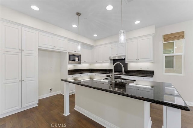 20304 Estuary Ln, Newport Beach, CA 92660 - kitchen with stainless steel microwave, white cabinetry, dark wood-style flooring, hanging light fixtures, and recessed lighting