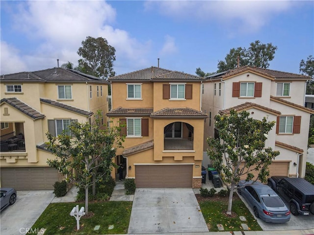 20304 Estuary Ln, Newport Beach, CA 92660 - view of property with a garage, driveway, a tiled roof, and stucco siding